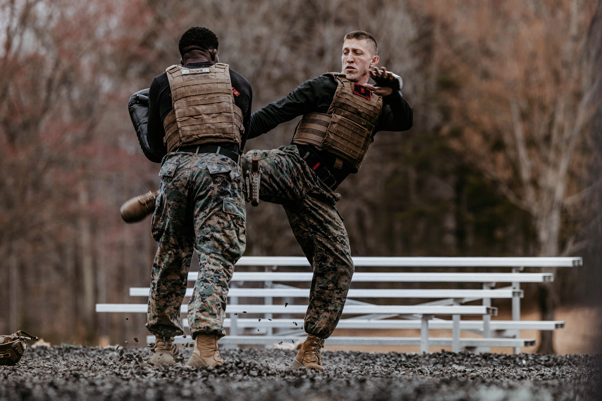 Marine officers in tactical vests conducting hand-to-hand combat training during Basic School Phase 1 individual skills development.