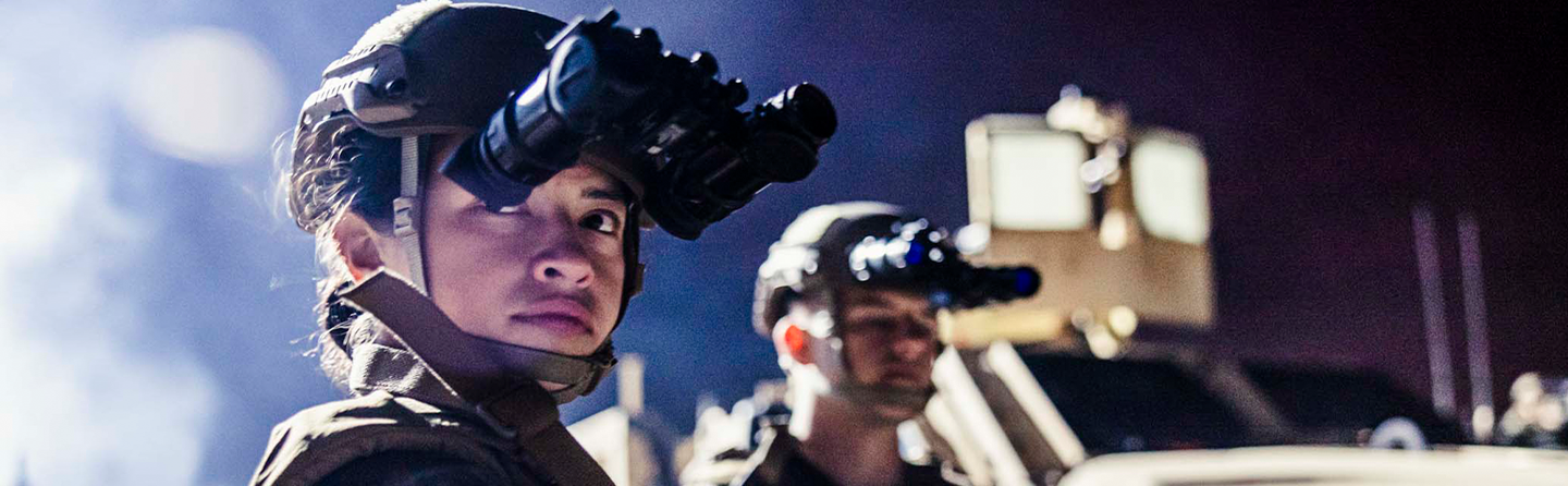 Marine with night vision goggles and tactical gear preparing for deployment to operating forces.