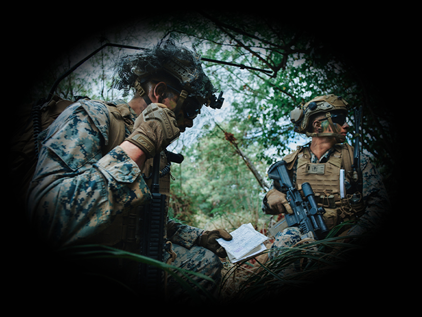 Two U.S. Marines using communication devices